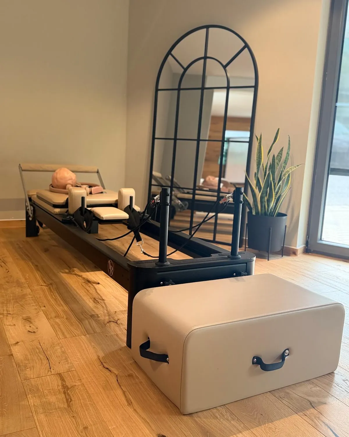 Reformer und Sitzbox vor einem schwarzen Bogenspiegel in der Robinson Reformer Lounge